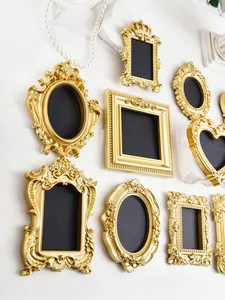 Detailansicht von goldenen Miniatur-Bilderrahmen im verzierten viktorianischen Stil.