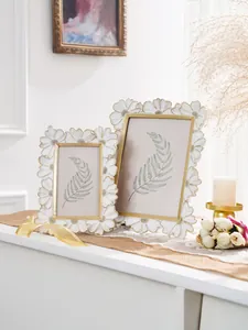 Primer plano de marcos de fotos decorativos de resina con margaritas y borde dorado