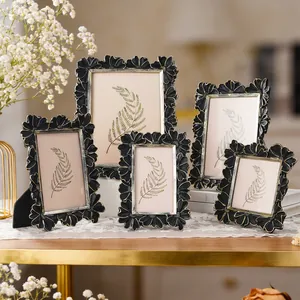 Macro view of black and gold vintage daisy flower patterned 3D photo frames.