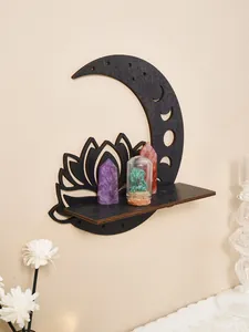 Close-up detail of black wooden moon and lotus wall shelf displaying healing crystals