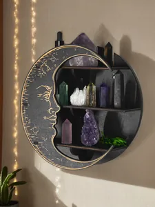 Detail view of a black crescent moon wooden shelf displaying various healing crystals