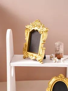 Macro detail view of ornate gold vintage photo frame with Baroque relief patterns