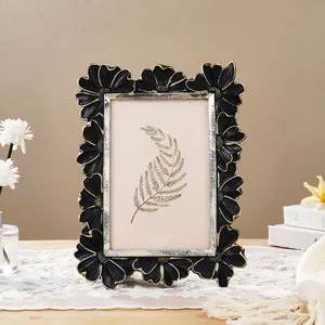 Detailed view of vintage black and gold floral photo frame featuring a 3D daisy border design
