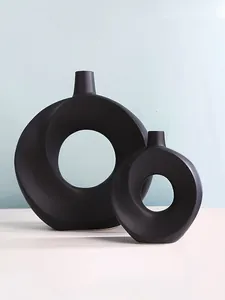 Detailansicht minimalistischer schwarzer Donut-Vasen für moderne Tischdekoration