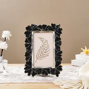 Close-up of vintage black and gold daisy floral picture frame for desktop decoration