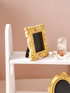 Close-up of golden vintage embossed photo frame with intricate baroque detailing
