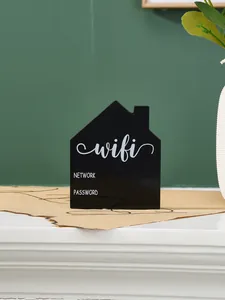Close-up of a house-shaped black WiFi password sign for home and hotel desktop decor