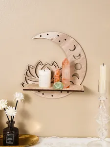 Detail view of wooden moon and lotus wall shelf with crystals and candle decor