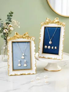 Detail of French gilded bow jewelry stands with velvet lining for necklaces and earrings