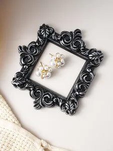 Close-up of vintage resin picture frame showing intricate embossed floral texture