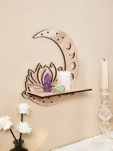 Close-up of a wooden moon and lotus wall shelf displaying healing crystals and candle