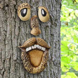Close-up detail of funny resin old man face features attached to a natural bark tree trunk