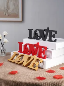 Wooden LOVE letter table sign with butterfly decor, romantic wedding party decoration.