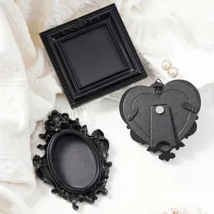 Set of vintage black mini magnetic photo frames in square, oval and heart shapes