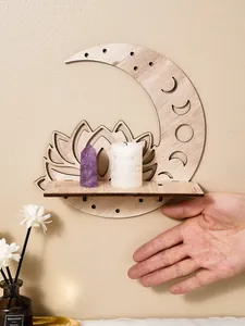 Detailed view of crescent moon and lotus wooden wall shelf with candle and crystal props