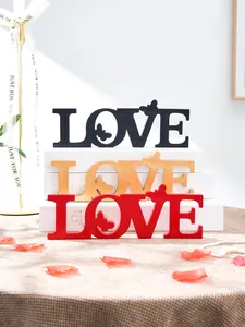Wooden LOVE letter ornament with butterfly design for romantic wedding and party decor.
