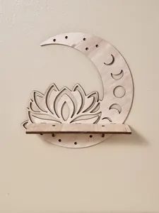 Wooden moon and lotus wall shelf detail showing wood grain and carved moon phases