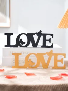 Detail view of wedding love wooden letter decor with butterfly silhouette for romantic party.