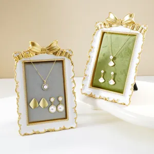 Elegant French gold bow jewelry display stand with velvet lining for necklace earring storage