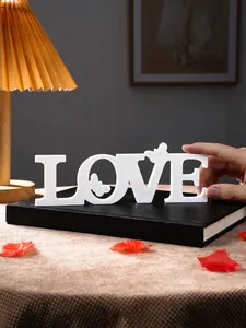 Close-up detail of the white LOVE letter decorative ornament with butterfly cutout.
