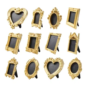 Collection of 12 vintage golden ornate picture frames for desktop decoration