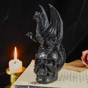 Gothic black dragon perched on a skull figurine decoration for Halloween table decor
