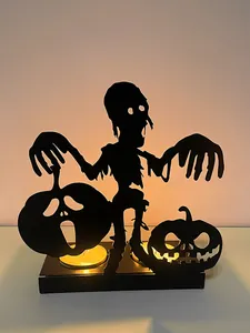 Detailed black iron Halloween zombie silhouette candle holder with warm candle light glow