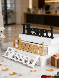 Close-up detail of decorative 'Blessed' letter signs in elegant black, gold, and white finishes