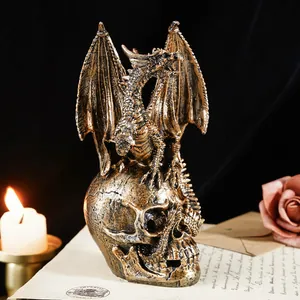 Detailed antique bronze dragon figurine perched on a skull, gothic home decor accent piece.