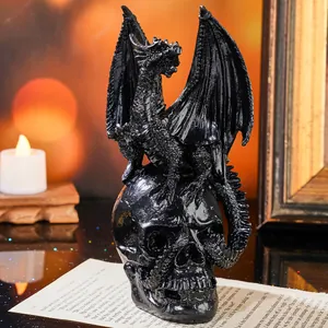 Intricately detailed black dragon perched on a human skull Halloween decoration