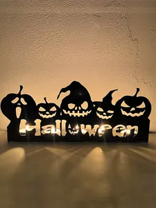 Detailed view of the Halloween pumpkin candle holder glowing with warm candlelight
