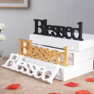 Decorative 'Blessed' word signs in black, gold, and white for home or wedding decor.