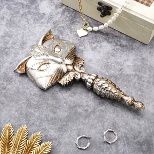 Detailed view of vintage fox-shaped resin hand mirror with antique silver finish