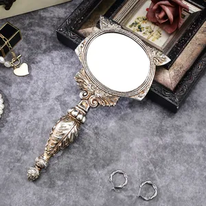 Ornate vintage silver resin handheld mirror with fox ears and intricate floral carvings