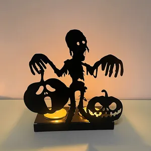 Atmospheric black iron hollow Halloween candle holder featuring zombie and pumpkin silhouettes