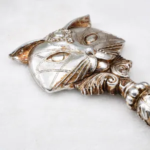 Close-up detail of ornate fox-shaped resin handheld mirror with antique silver finish