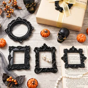 Ornate black Baroque mini photo frames displayed with Halloween-themed props and skulls.