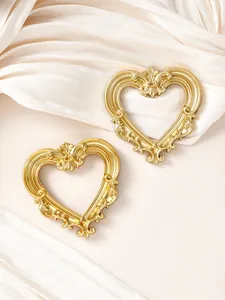 Cornici vintage a forma di cuore dorate con intagli barocchi su sfondo di seta crema