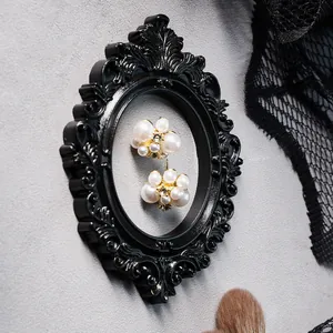 Detailed view of a vintage Baroque style black mini frame with intricate relief carvings