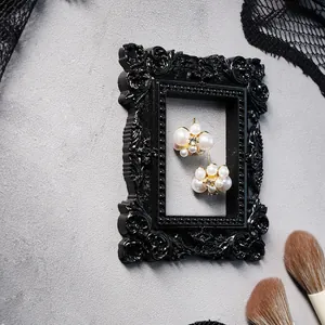 Detail of vintage black Baroque mini photo frame with ornate embossed patterns for display