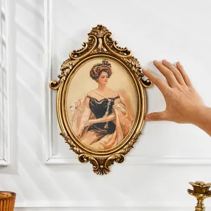 French vintage golden carved oval photo frame with European aristocratic lady portrait