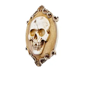 Vintage 3D skull wall relief with ornate gold carved frame for Halloween decor