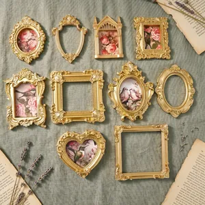 Detailed view of various antique gold magnetic photo frames for Polaroid photos.
