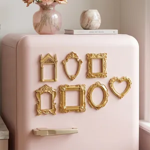 Detailed view of ornate gold magnetic mini photo frames on a pink refrigerator