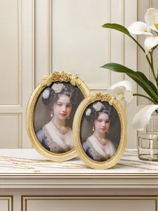 Close-up of European vintage oval gold resin picture frames with rose carving details