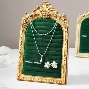 Vintage European arched velvet jewelry display frame with gold carved borders