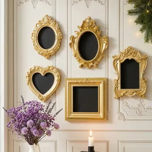 Collection of mini vintage gold embossed photo frames used as DIY fridge magnets on wall