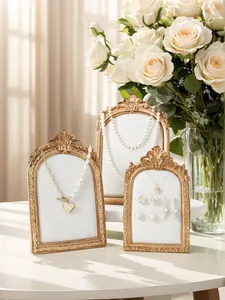 Vintage resin photo frame jewelry display stand set, elegant gold ornate necklace holder.