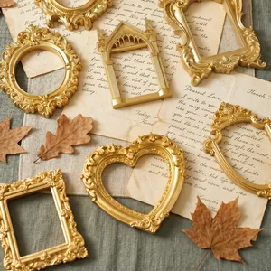 Detailed view of various ornate gold magnetic mini photo frames on vintage props