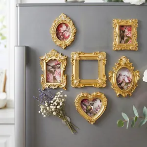 Detail shot of vintage gold ornate magnetic picture frames for refrigerator decor.